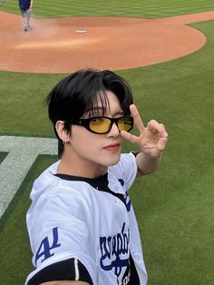 a baseball player is making the peace sign with his hand