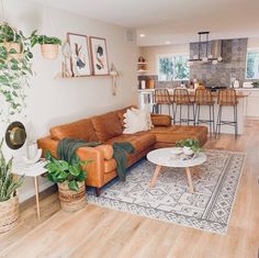 a living room filled with furniture next to a kitchen