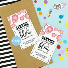 two service cards are sitting on top of a brown envelope with confetti around it