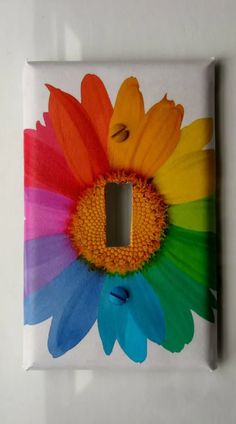 a multicolored flower light switch plate cover