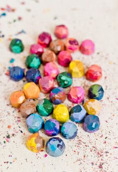 there are many different colored stones on the table together and one is scattered with sprinkles