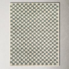 a white and black checkered rug on a wall