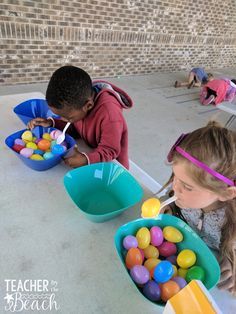 two children are painting easter eggs in buckets