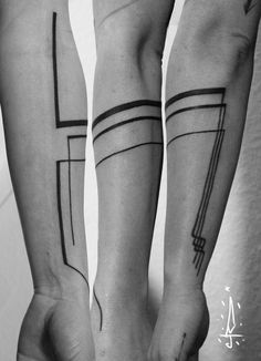 two people with tattoos on their legs and one is holding the other's hand