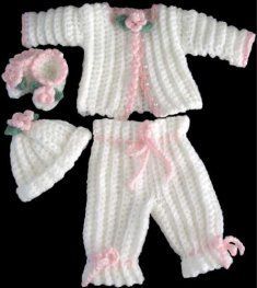 two white knitted baby clothes with pink flowers