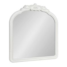 a white mirror with an ornate design on the top and bottom edge, against a white background