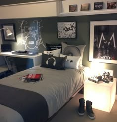 a bed room with a neatly made bed and pictures on the wall