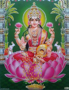 the hindu goddess sitting on top of a lotus flower