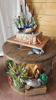 two tiered baskets with plants and other items on top of each one in front of a wooden wall