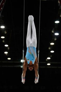 a man is doing tricks on the rings