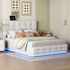 a white bed sitting in a bedroom on top of a hard wood floor