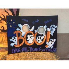 there is a sign that says booj and three ghost faces on it with the word booj painted on it