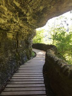 a wooden walkway leading to a cave entrance