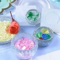 three bowls filled with different colored candies on top of a table