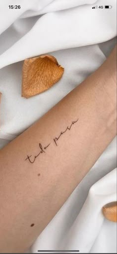 a person with a tattoo on their arm that reads, thank mom and has the word love written in cursive font