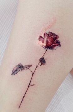 a small rose tattoo on the right thigh