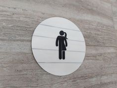 Add a touch of rustic charm and elegance to your bathroom with our restroom wood signs. These wc signs are meticulously handcrafted using high-quality materials including plywood and acrylic.  The sign features 3D design of white silhouettes, symbolizing a unisex toilet.  It comes in various sizes, ranging from 5.5 inches to 15 inches in diameter, allowing you to choose the perfect fit for your restroom door.  Each sign is cut out and painted in the workshop, ensuring attention to detail and a flawless finish. The wood grain and color intensity may slightly differ from the picture, adding a touch of individuality to each piece.  The sign comes with high-grade adhesive tape on the back. Simply peel and stick it to your desired location. This makes installation quick and hassle-free.  Custom Gender Neutral Restroom, Neutral Restroom, Unisex Toilets, Toilet Door Sign, Toilet Door, Restroom Sign, Door Sign, Door Signs, Door Hangers