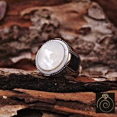 "Men's silver ring with a mother of pearl gemstone which will give you a head turning presence. This cool, elegant cocktail gents' ring has an exquisite design for the polished, refined, and distinguished man. Perfect for casual and formal events, it will make your friends envious as you walk into commanding attention. All sizes are avaliable. If you have extra big size (out of cart) please ask avaliability. One of high quality handmade silver ring from our designs. All my designs are coming fro Classic Mother Of Pearl Round Rings, Classic Mother Of Pearl Rings, Handmade White Signet Ring, Classic White Mother Of Pearl Rings, White Mother Of Pearl Rings, White Gemstone Signet Ring Gift, White Polished Mother Of Pearl Rings, Elegant White Skull Ring For Gift, Mother Of Pearl Wedding