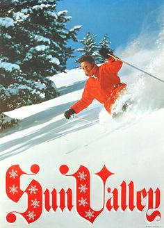 a man riding skis down the side of a snow covered slope with trees in the background