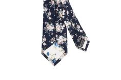 Navy Blue Floral Tie Material:Cotton Blend Approx Size: Max width: 6.5 cm / 2.4 inchesSmall width: 4 cm / 1.6 inchesLength: 148 cm / 58 inches Color: Blue The FINLEY Navy Floral Skinny Tie is the perfect accessory for any sharp dressed man. Made from high-quality materials, this tie is sure to make a lasting impression. The navy color and floral pattern are perfect for any formal occasion, while the skinny cut keeps you looking modern and stylish. Whether you're dressing up for a wedding or head Casual Blue Ties For Spring, Casual Blue Spring Ties, Adjustable Blue Floral Print Tie, Blue Floral Tie, Floral Necktie, Sharp Dressed Man, Flower Ideas, Blue Tie, Blue Ties