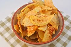 a bowl filled with potato chips on top of a checkered table cloth