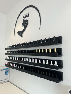 there are many bottles on the wall in this salon shop, and one is for sale