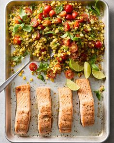 salmon, corn and tomatoes on a tray with a fork next to it that is ready to be cooked