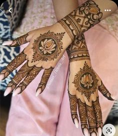 the hands are decorated with henna designs