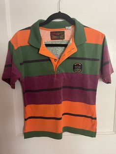 Listing is for a vintage 1990s/Y2K  Bugle Boy boys size striped shirt. Laying flat the measurements are approximately 17 inches pit to pit and 22 inches in length. Shirt is in good vintage condition. Tag size says 12-14. Comes from a non-smoking home. Thank you so much for looking.😃😃 Y2k Striped Cotton Tops, Retro Collared T-shirt For Streetwear, Casual Green Polo Shirt For Streetwear, Casual Multicolor Polo Shirt With Striped Collar, Retro Green Short Sleeve Polo Shirt, Vintage Green Cotton Polo Shirt, Vintage Green Short Sleeve Polo Shirt, Retro Green Collared T-shirt, Multicolor Cotton Polo Shirt With Striped Collar