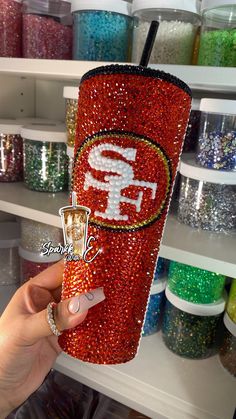 the san francisco giants glitter tumbler is on display in a store with other items