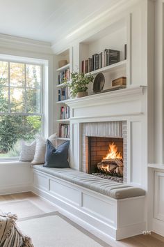 a living room with a fire place and bookshelves on the wall above it