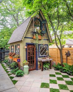 an image of a small garden shed with potted plants on the front and side