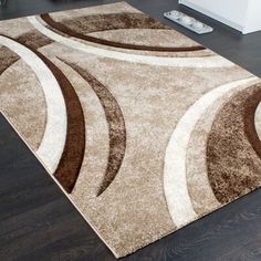 a brown and white area rug on top of a hard wood floor in a living room