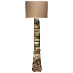 a lamp that is made out of wood and has a beige shade on the top