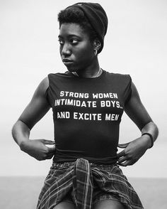 a woman wearing a t - shirt that says strong women intimate boys and excite men