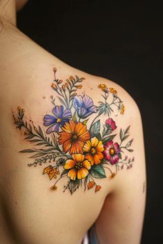 a woman's shoulder with colorful flowers on it