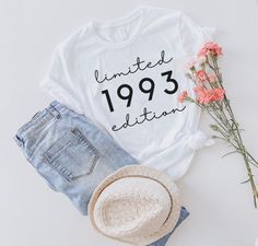 a t - shirt that says limited 1939 is next to some shorts and a straw hat