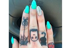 a woman's hand with some tattoos on it