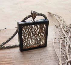 a piece of jewelry sitting on top of a wooden table