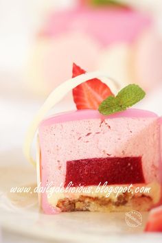 there is a piece of cake on the plate with strawberries and mint leaves in it