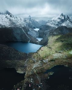 the mountains are covered in snow and have some water on them as far as they can be seen