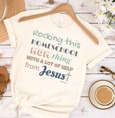 "Our Rocking This Homeschool Mom Thing With A Lot of Help From Jesus Shirt is the perfect shirt for the Christian homeschool mom! Our premium tee is soft and lightweight, with just the right amount of stretch. It's comfortable and flattering! QUALITY We use a high quality direct to garment printing process which leaves a permanent image using high quality inks. These images will not rub, peel, or scratch off. SIZING This shirt is unisex sized, so it may run big for women. When in doubt of your s Casual Letter Print T-shirt, Casual T-shirt With Letter Print, Cotton Crew Neck T-shirt For Home, Cotton Crew Neck Tops For Home, Casual Relaxed Fit Tops For Home, Homeschool Shirts, Reading Lesson Plans, Cute Shirt Designs, Jesus Shirt