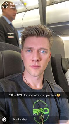 a man sitting in an airplane with his head turned to the side and looking at the camera