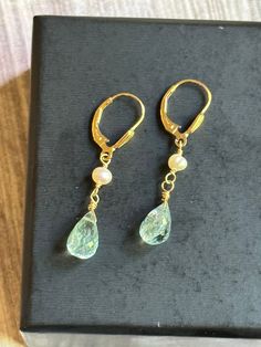 "These aquamarines are very fine quality.  Lovely bright aqua blue coloring with micro faceting.  The aquamarines have been paired with beautiful pearls and wire wrapped in 14k gold fill and suspended from 14k gold fill fan detailed leverbacks.  Earring Measurements: 1 1/2\" long by 1/4\" wide.  These earrings will come gift boxed perfect for gift giving!" Gold Aquamarine Gemstone Earrings, Elegant Turquoise 14k Gold Filled Earrings, Handmade Gold Aquamarine Earrings, Gold Aquamarine Teardrop Jewelry, Gold Aquamarine Drop Earrings, Gold Aquamarine Briolette Jewelry, Handmade Gold Earrings With Blue Topaz, Artisan Necklace, Solitaire Necklaces