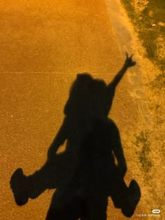 the shadow of a person holding a skateboard