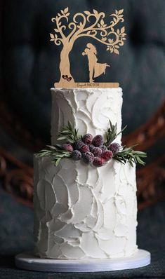 a white wedding cake topped with frosting and decorations