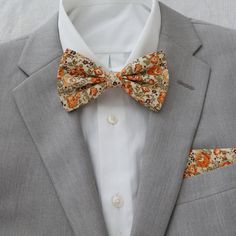 Darwin Marigold Yellow Floral Collection includes the following:  adult necktie and bow tie with matching pocket squares.                                              FREE swatches of this collection is available upon request.                                                                                          Color:  Marigold Material:  Cotton                                                                                                                         Adult Skinny Necktie:  approx Gold Bow Tie For Business, Fitted Bow Tie For Father's Day, Gold Dapper Ties For Weddings, Formal Orange Bow Tie, Classic Gold Bow Tie For Groom, Gold Classic Bow Tie For Groom, Fitted Bow Tie For Groom, Marigold Wedding, Mens Wear Wedding