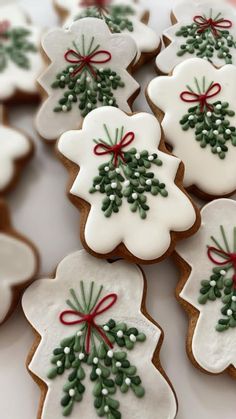 decorated cookies with bows and holly on them