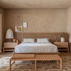 a bed sitting in a bedroom on top of a wooden floor next to a window