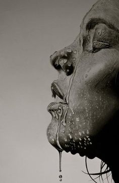 a black and white photo of a woman's face with water dripping from her mouth